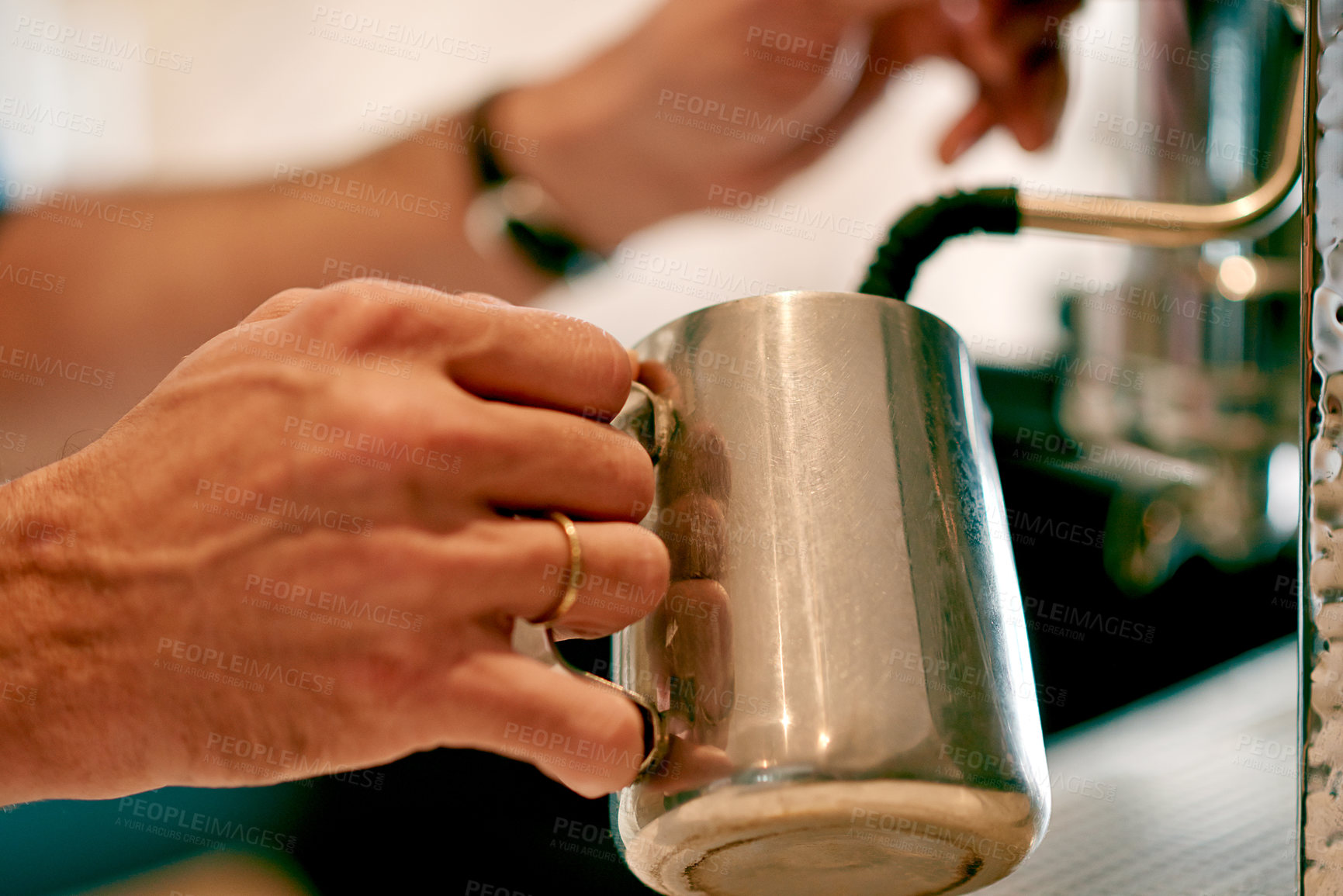 Buy stock photo Hands, milk and barista with froth, coffee machine and friendly service with skills. Closeup, person and employee in restaurant, equipment and process with caffeine, steel container and heating