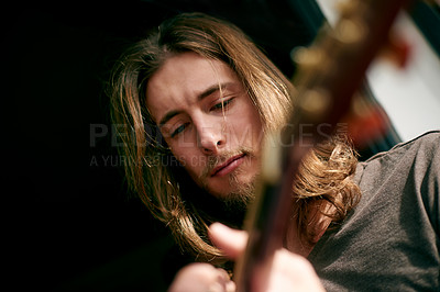 Buy stock photo Playing, musical and man with guitar in home with skill for instrument, creativity or practice. Artist, rehearsal and person with acoustic strings for song with talent, hobby or rhythm from below.