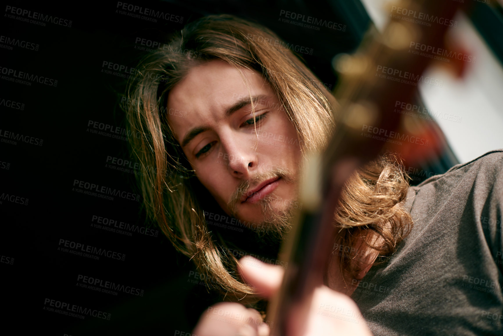 Buy stock photo Playing, musical and man with guitar in home with skill for instrument, creativity or practice. Artist, rehearsal and person with acoustic strings for song with talent, hobby or rhythm from below.