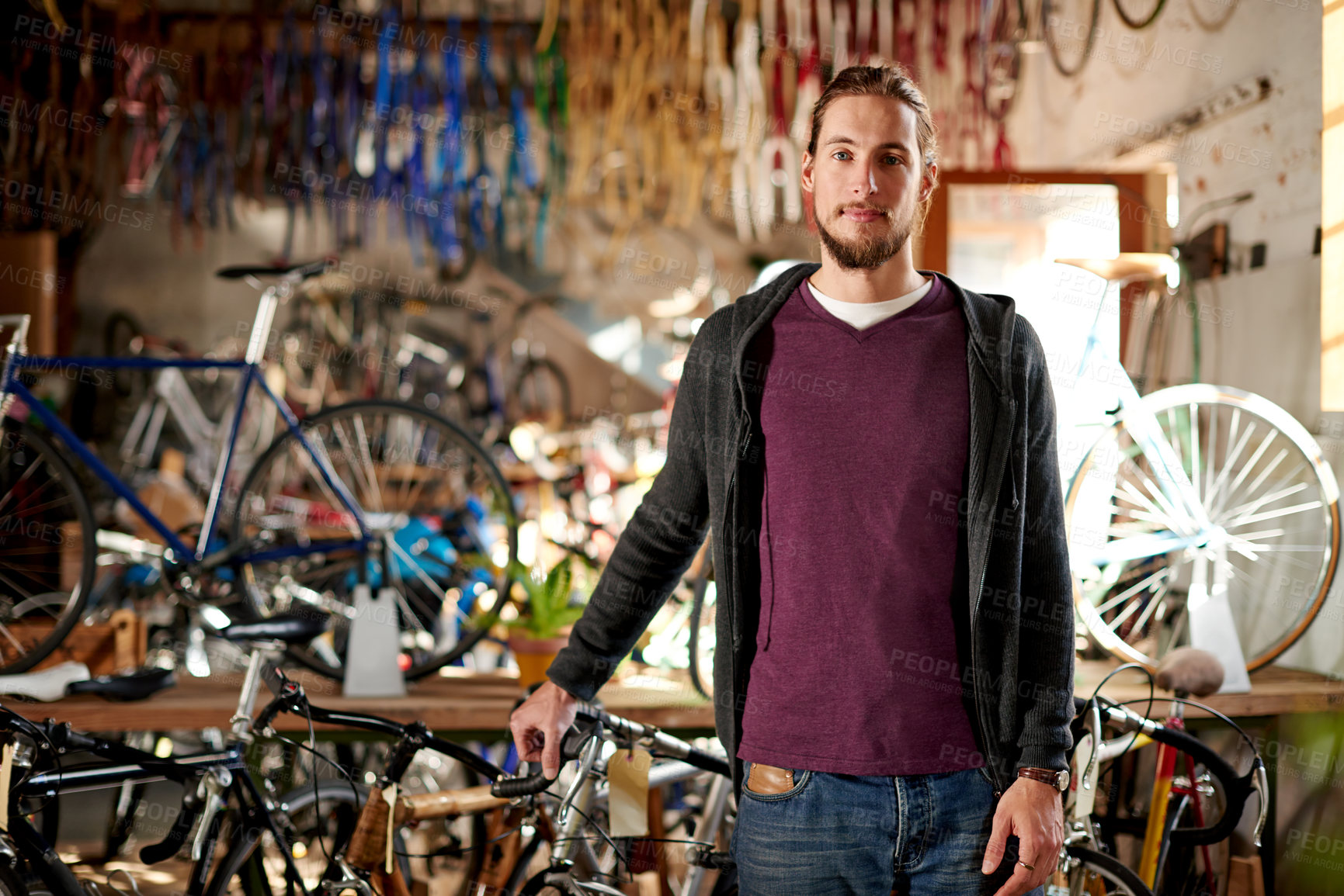 Buy stock photo Man, portrait and handyman in bike repair shop for maintenance, confidence and garage. Bicycle, mechanic and service with a professional technician for startup, small business and workshop for fixing