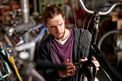 Buy stock photo Man, bike repair and thinking at workshop with cable inspection, maintenance or services at garage. Person, bicycle and safety check with brakes, tyres and solution for alignment at small business