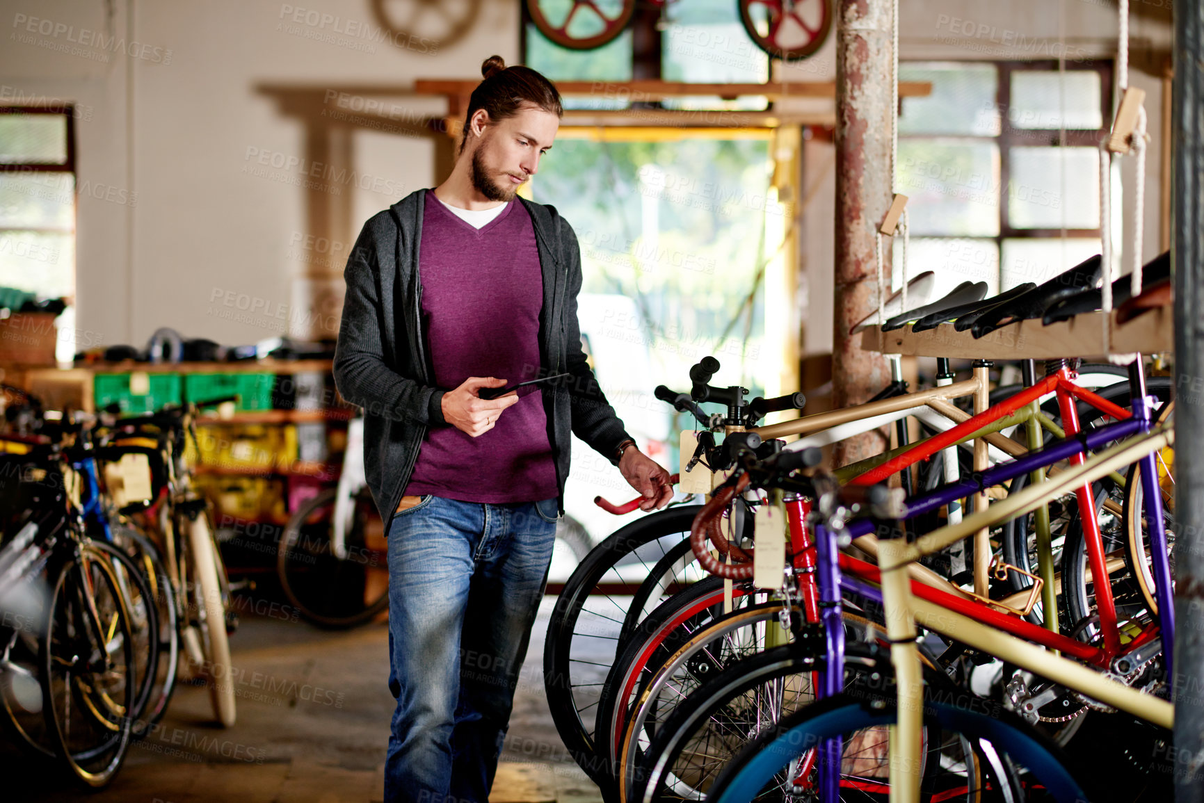 Buy stock photo Tablet, choice or man in bicycle shop to check inventory, wheel or research in small business. Frame options, mechanic and owner in store for maintenance update, inspection or bike sales in garage