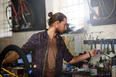 Buy stock photo Mechanic, workshop and man with tools for bicycle for repair, fixing and bike maintenance. Small business, cycle technician and person with equipment for wheel, gears and cycling service in garage