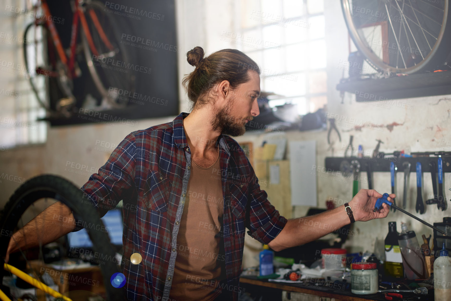 Buy stock photo Mechanic, workshop and man with tools for bicycle for repair, fixing and bike maintenance. Small business, cycle technician and person with equipment for wheel, gears and cycling service in garage