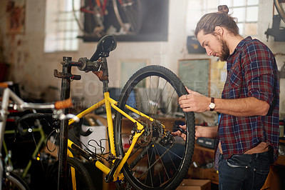 Buy stock photo Man, repair or wheel with bicycle for maintenance inspection or fix in workshop or garage. Male person, bike mechanic or cycle technician with equipment, tools or supply for replacement service