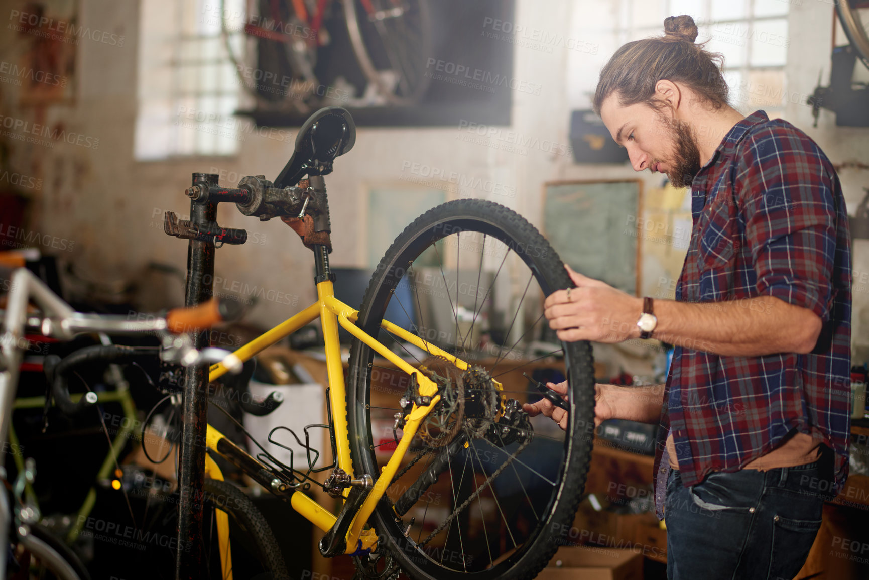 Buy stock photo Man, repair or wheel with bicycle for maintenance inspection or fix in workshop or garage. Male person, bike mechanic or cycle technician with equipment, tools or supply for replacement service