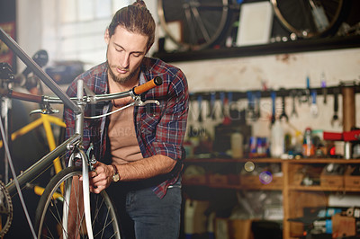 Buy stock photo Man, repair or tyre with bicycle for maintenance inspection or fix in workshop or garage. Male person, bike mechanic or cycle technician with part for build, wheel balancing or replacement service