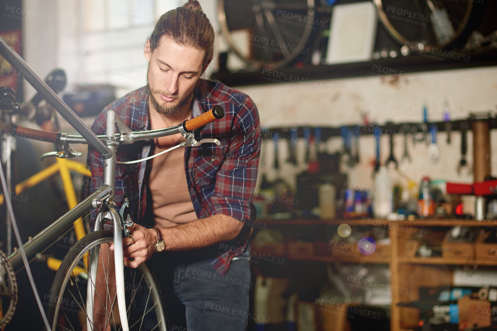 Buy stock photo Man, repair or tyre with bicycle for maintenance inspection or fix in workshop or garage. Male person, bike mechanic or cycle technician with part for build, wheel balancing or replacement service