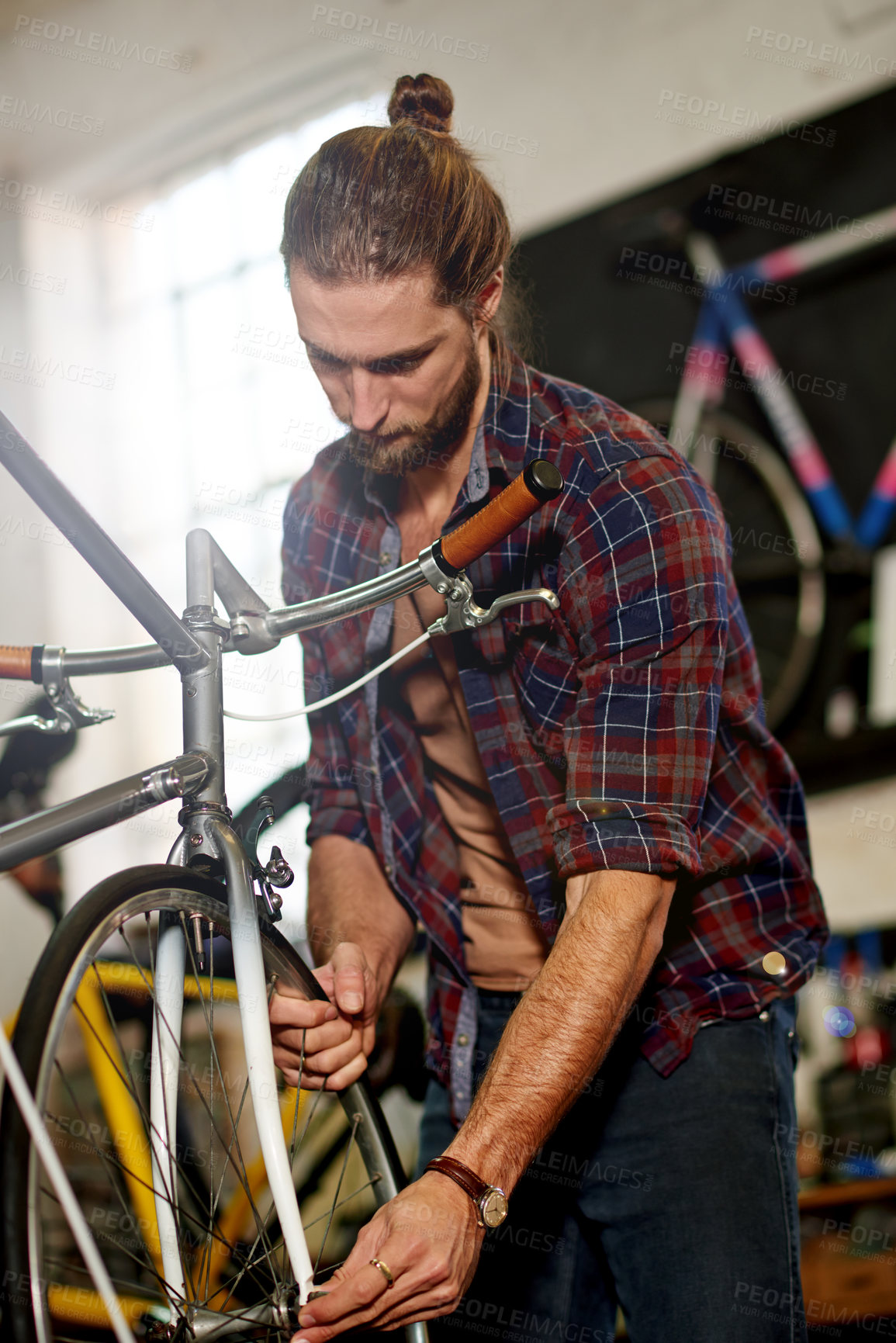 Buy stock photo Man, bicycle and repair tyres at garage with services, equipment and wheel alignment at small business. Person, technician and bike mechanic with low angle, safety check and inspection at workshop