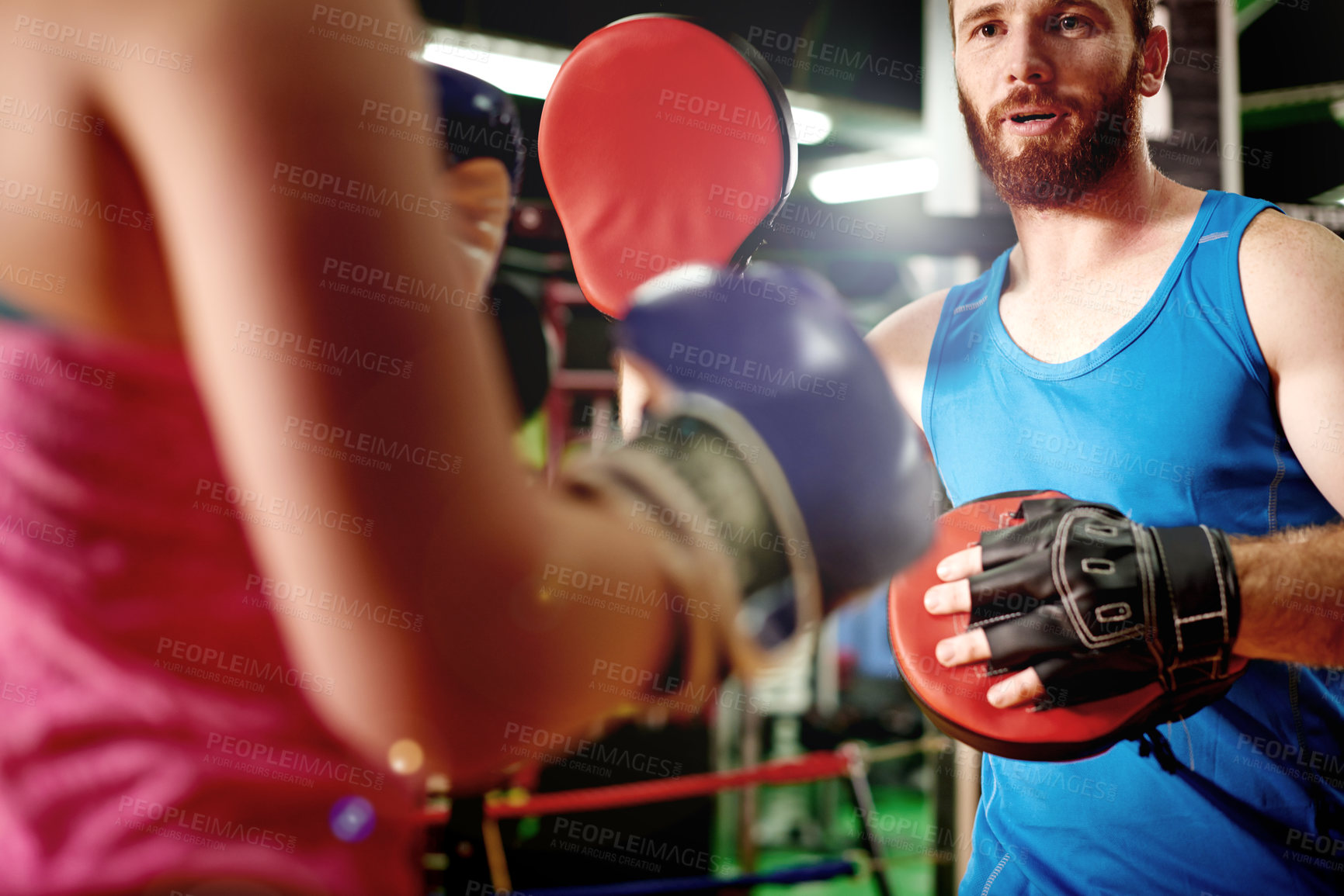Buy stock photo Boxer, teaching or woman with trainer for fighting exercise, boxing punch or self defense skills. Pads, learn or client in sports practice for training technique or fitness workout with coach in gym