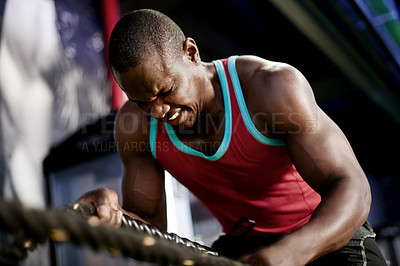 Buy stock photo Battle rope, intense and fitness with black man in gym for bodybuilder, training and muscle challenge. Exercise equipment, resilience and athlete strength with person in sports club for wellness