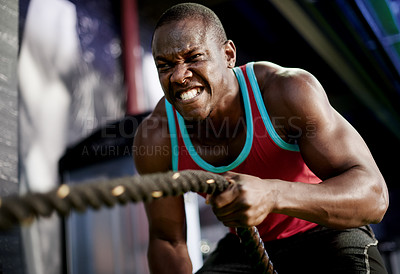 Buy stock photo Battle ropes, strong and fitness with black man in gym for bodybuilder, training and muscle challenge. Exercise equipment, intense and athlete with person in sports club for wellness and commitment