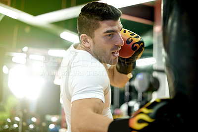 Buy stock photo Man, punching bag and training at gym with boxing, power and mixed martial arts with gloves. Person, fighter and boxer with equipment for workout, exercise or combat sport with flare at dojo facility