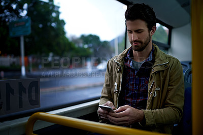 Buy stock photo Reading, phone and travel with man on bus for location app, tracking journey and social media. Communication, public transportation and online metro update with person in vehicle for passenger trip
