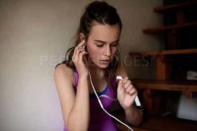 Buy stock photo Fitness, home and girl with earphones for music, radio or listening to podcast for motivation. Audio, teenager and athlete streaming song, sound or exercise playlist with technology for preparation