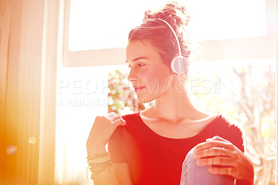 Buy stock photo Music, headphones and girl in home with lens flare, podcast or listening on audio app. Digital, sound track and young female in bedroom with technology, media or radio streaming on virtual service.