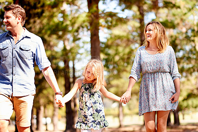 Buy stock photo Parents, kid hiking and holding hands in woods for family holiday, sightseeing and laugh together. Mother, father and child in forest for walking, funny joke and trekking with happy girl on journey
