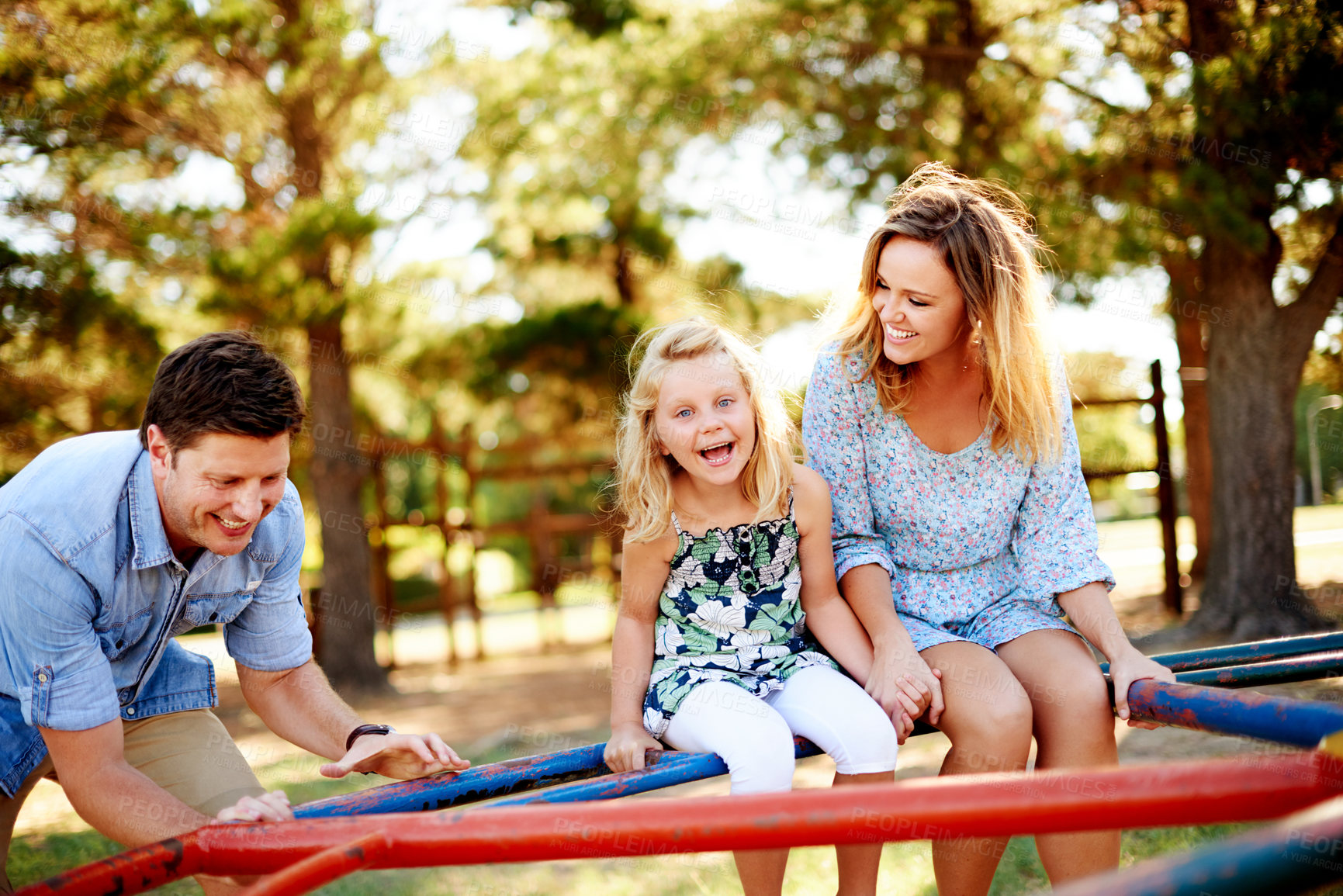 Buy stock photo Smile, parents and kid on carousel at playground for holiday fun, play games and bonding together. Happy, family or child on merry go round for spinning ride, activity and balance support on vacation