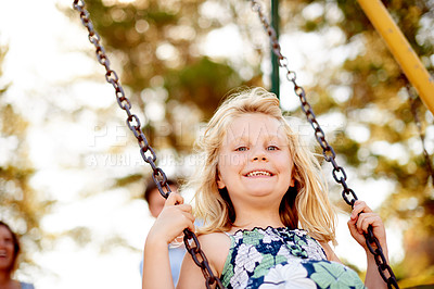 Buy stock photo Happy, playground and child at park with swing in air, parents and laugh for fun childhood memories. Smile portrait, nature and girl outdoor with people, connection and playing for family bonding.