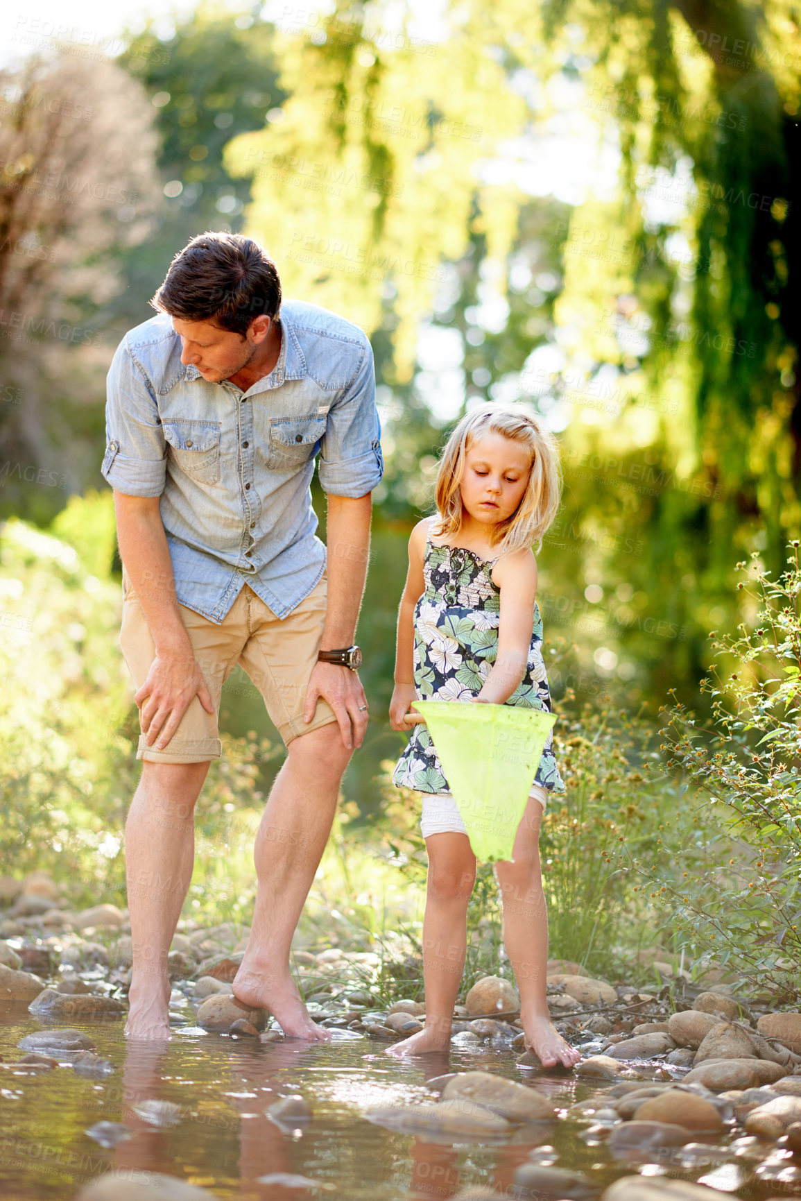 Buy stock photo Father, child and fishing with net in river for holiday adventure, teaching skills and bonding. Family activity, single dad and girl catch fish in water for summer vacation, learning and development