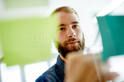Buy stock photo Glass, creative and man with sticky notes, office and brainstorming for marketing strategy or ideas. Business, brand manager and person with info for advertising, schedule and research for project