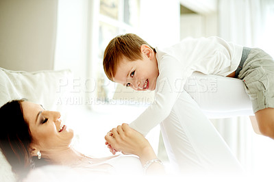 Buy stock photo Playing airplane, mother and child on bed with smile, love and connection for bonding together. Family fun, parent and son in home with support, relationship building and flying game on weekend break