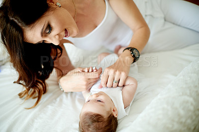 Buy stock photo Bedroom, cuddle or development with baby and mother in home together for bonding, growth or security. Love, relax and smile of woman parent with infant child on bed in apartment for connection