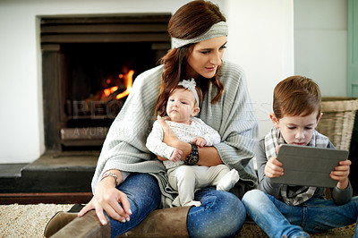 Buy stock photo Tablet, mother and kids in home for learning, streaming and bonding with app on internet. Tech, children and parent with baby for online education, game or relax on floor at fireplace with family