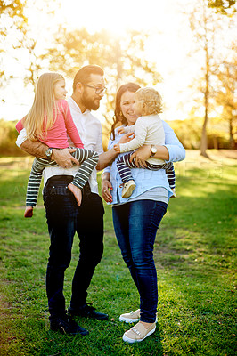 Buy stock photo Family, mother and father in park with children, bonding and relax for summer holiday and vacation. Happiness, man and woman in nature with sunshine, garden and flare in outdoor on weekend.