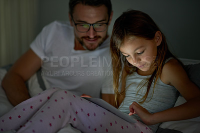Buy stock photo Night, parent and daughter in bedroom with tablet for digital bedtime story, kids app or playing games. Late, father and child in home with tech for reading ebook, watching video or bonding together