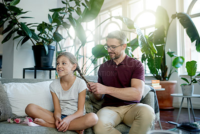 Buy stock photo Hair braid, man and girl in living room with bonding, helping and support for morning routine. Smile, daughter and single parent on couch with grooming, together and getting ready for school.