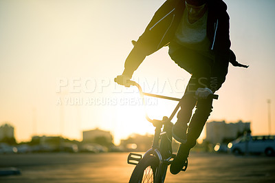 Buy stock photo Sunset, adrenaline and man on bicycle in city with tricks, fun or skills for activity with travel. Adventure, practice and person on bike training for competition, challenge or race in urban town.