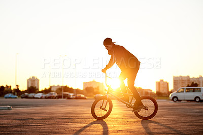 Buy stock photo BMX, flare and ride with man on bike in city for activity, adrenaline hobby or sports training. Exercise, balance and risk with extreme person on bicycle on street for action, cycling or energy