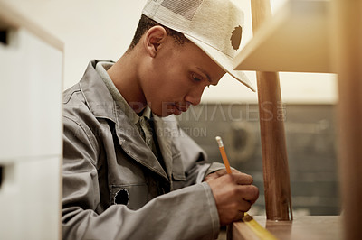 Buy stock photo Carpentry, man and furniture measurement in workshop for production, manufacturing or fix. African carpenter, pencil and tape for woodwork, repair or marking joinery points in factory with tools
