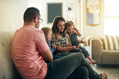 Buy stock photo Parents, children and streaming on couch with tablet, bonding and choice for film in family home. People, mother and father with girl kids, tech and app for movie subscription, relax or show at house