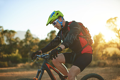 Buy stock photo Bike, dirt road and sports with man in mountains for outdoor adrenaline, adventure or training. Exercise, fitness and helmet with person cycling in nature for challenge, competition or performance