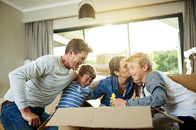 Buy stock photo Happy, boxes and family packing in new home with sorting items for donation, charity or community. Cardboard, moving and parents helping children sort household supplies for relocation in house.