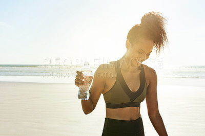 Buy stock photo Fitness, woman and bottle at beach with smile, gut health and electrolytes for body care in training. African athlete, space and drink at ocean for wellness with flare, hydration and exercise break.