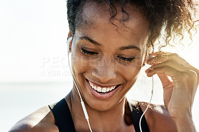 Buy stock photo Thinking, athlete and woman with earphones at beach for fitness, listening to music and podcast. Smile, female person and space with playlist audio for exercise, sports training and marathon practice