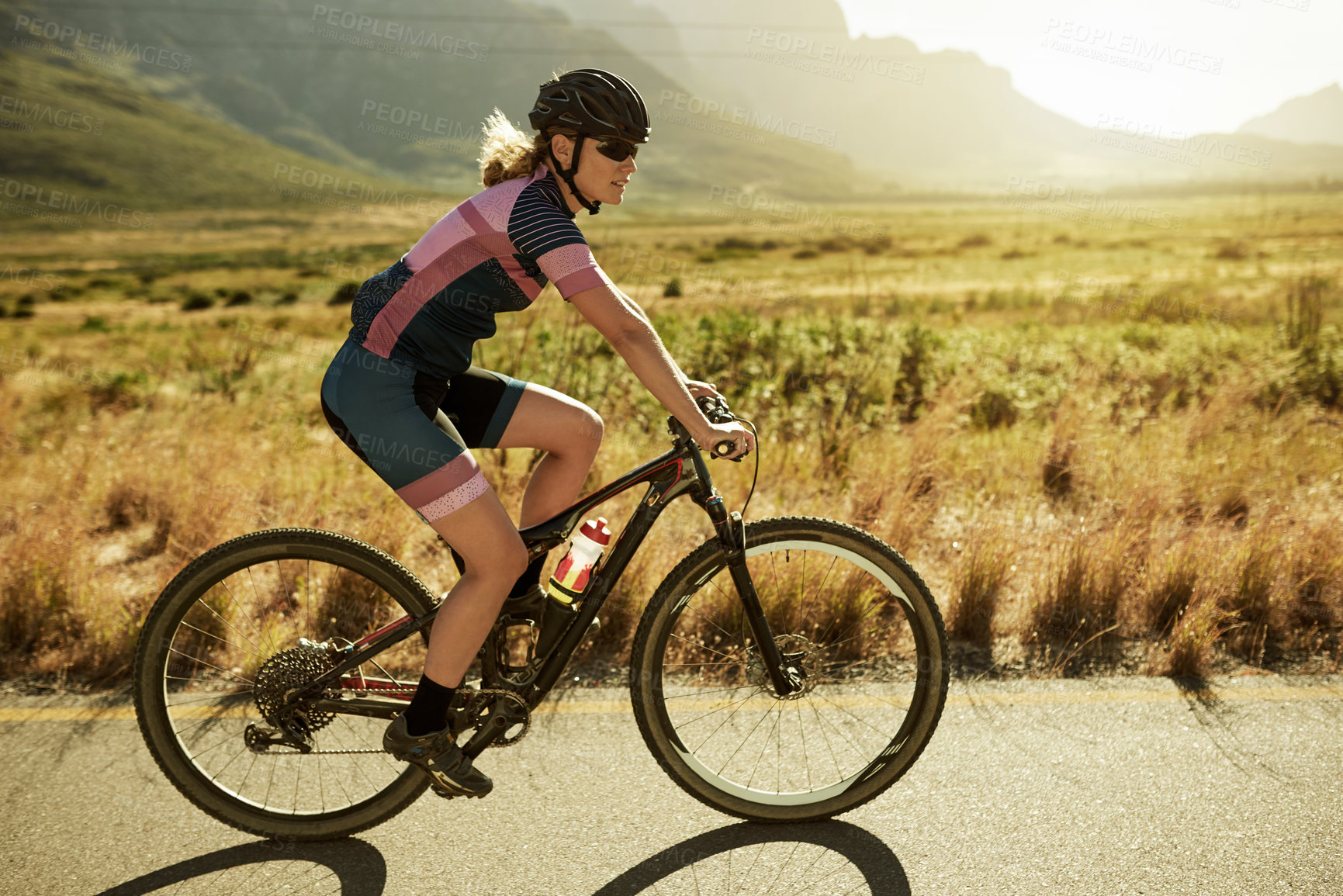 Buy stock photo Woman, cycling and road with bicycle in nature for mountain ride, exercise or outdoor workout. Active, female person or cyclist with helmet on bike for fitness, race or sport marathon in countryside