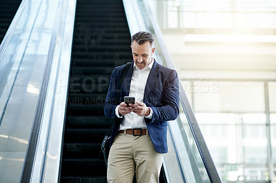Buy stock photo Escalator, airport and businessman with phone for trip, commute and arrival in lobby. Conference, professional and person on electric stairs on smartphone for flight schedule, news or travel info