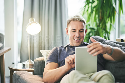 Buy stock photo Home, typing and man on sofa, tablet and relax with social media, ebook and connection. Apartment, tech and person on couch, online reading and communication with chatting, internet and digital app