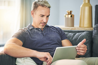 Buy stock photo Tablet, streaming and relax with man on sofa for website, connection and watching movie. Film subscription, entertainment and series browsing with person in living room of home for break and app