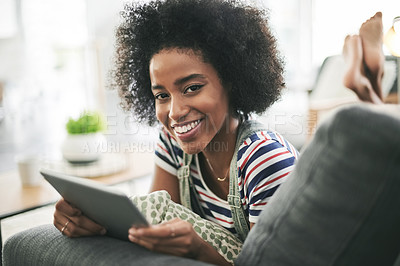 Buy stock photo Black woman, tablet and happy on sofa, relax and portrait with streaming, movies or ebook in home. African girl, smile and tech on couch, laying and app for film subscription at apartment in Nigeria
