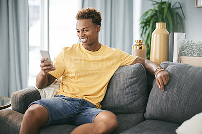 Buy stock photo Laugh, sofa and black man with phone in home for online chat, social media and funny message notification. Happy, relax and person on smartphone for internet joke, meme and networking on mobile app