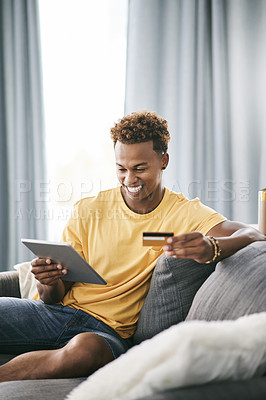Buy stock photo Black man, tablet and credit card on sofa, excited or budget for online shopping sale in home. Person, happy and fintech app for discount deal, ecommerce or digital banking for easy payment at house