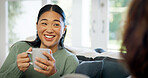 Sofa, coffee and happy woman relaxing with home visit for conversation, friendly chat or discussion. Female person, communication or smile with drink or mug for bonding, rumor or gossip in house
