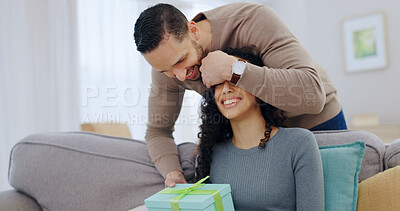 Buy stock photo Couple, home and surprise gift with cover for anniversary celebration, smile or partner appreciation. Eyes closed, giving present and happy people on sofa for care, relationship connection and love
