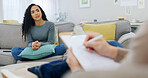 Woman, therapist and writing with clipboard for counseling, emotional support or listening in home. Female person, client and talking with counselor for therapy session, treatment or psychology