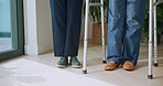 Legs, people and helping with walker for physio, balance and mobility support for rehabilitation. Feet, physiotherapist and patient with disability for checkup, stability aid and physiotherapy guide